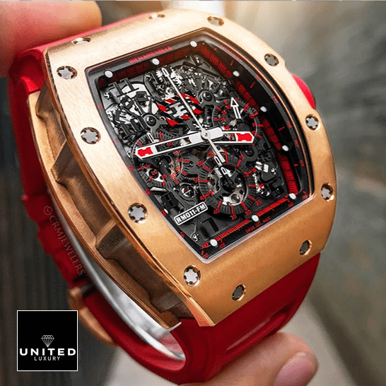 Richard Mille Black Dial Gold Bezel Replica on the fingers